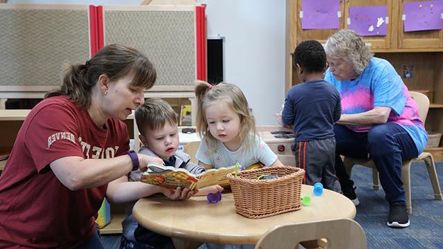 Two HCDC aides working with young children